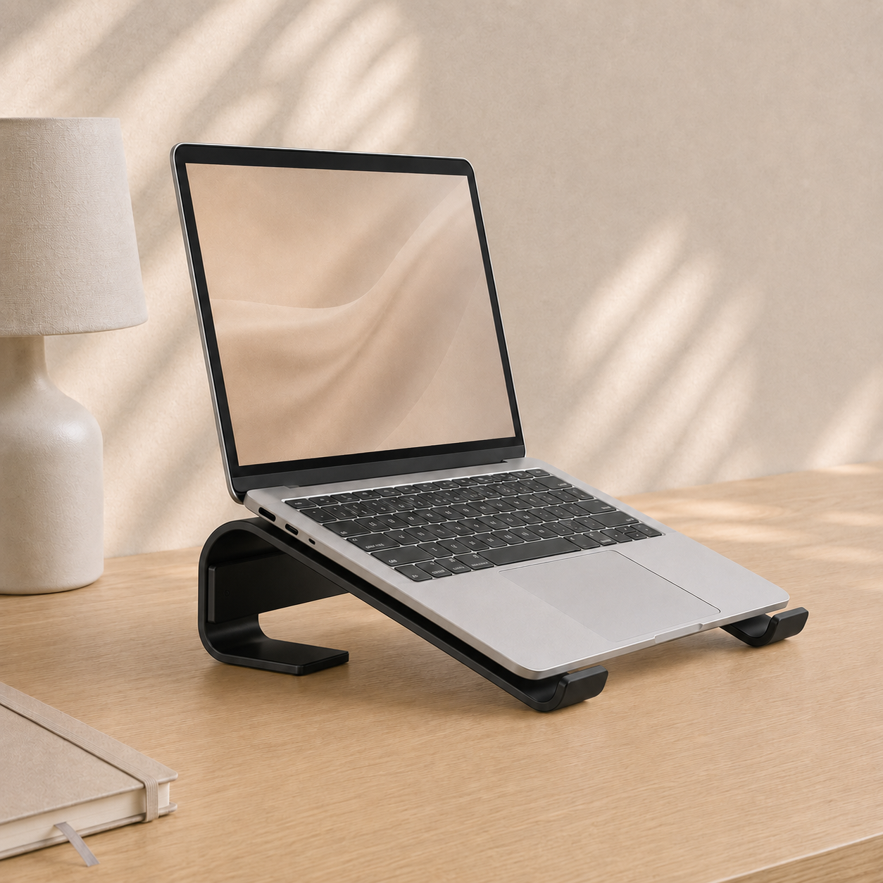 Black aluminium laptop stand shown from a three-quarter angle